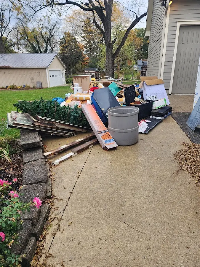 Dumpster being loaded with debris for Commercial Dumpster Rental in Lanett